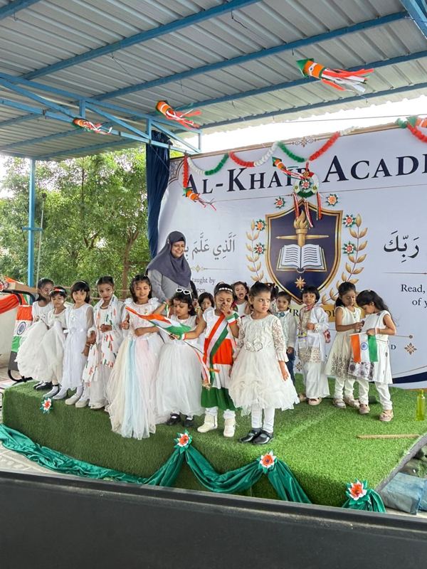 Young students performing with the tricolour