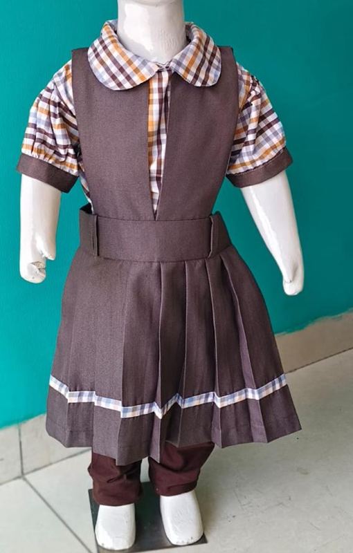 Girls uniform: checked blouse with brown pinafore